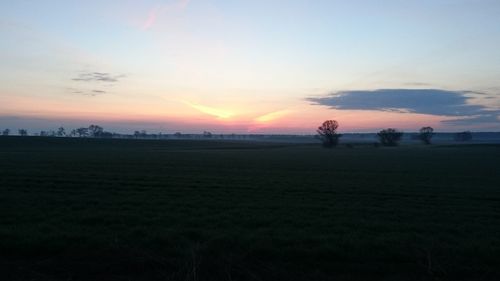 Scenic view of field against sky during sunset