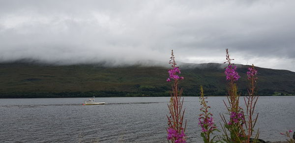 Scenic view of lake against cloudy sky