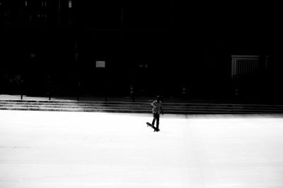 Full length of woman standing in park at night