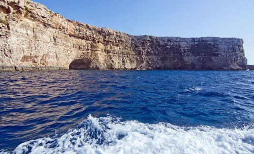 Scenic view of sea against clear blue sky