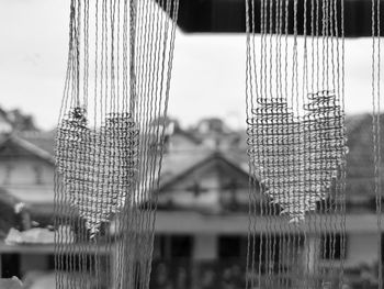 Close-up of  window curtains against sky