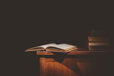 Close-up of books on table against black background