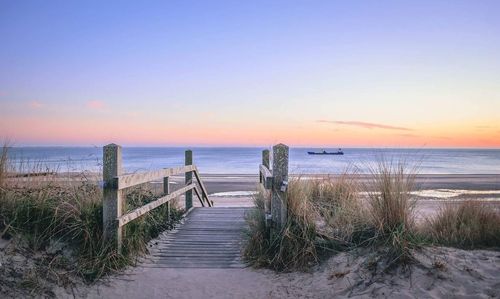 Scenic view of beach against sky during sunset