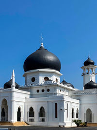 Mosque known as masjid alwi with sky blue background as a ramadhan and eid muslim concept
