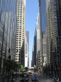 View of city street and buildings against sky