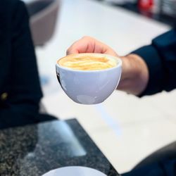 Cropped image of hand holding coffee cup