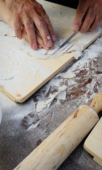 High angle view of man preparing food on cutting board