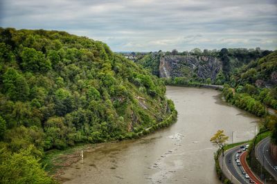 Scenic view of river amidst trees against sky