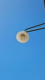 Low angle view of lamp post against blue sky