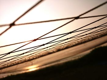 Close-up of cables against sky during sunset