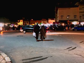 People on city street at night