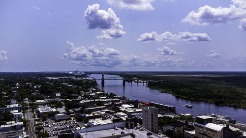 High angle view of townscape by sea against sky