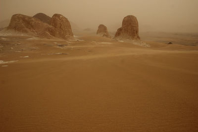 Rock formations in desert against sky