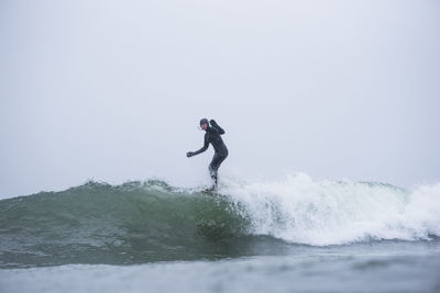 Woman surfing during winter snow