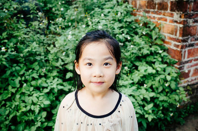 Portrait of cute girl standing outdoors