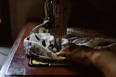 Close-up of person working on sewing machine