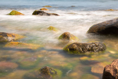 Scenic view of rocks on sea shore