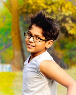 Portrait of boy smiling while standing on field