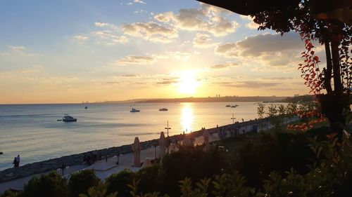 Scenic view of bay against sky at sunset