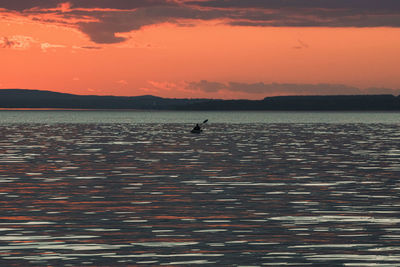 Scenic view of sea against orange sky