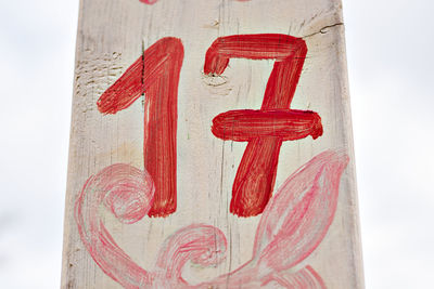 Close-up of red text on wood