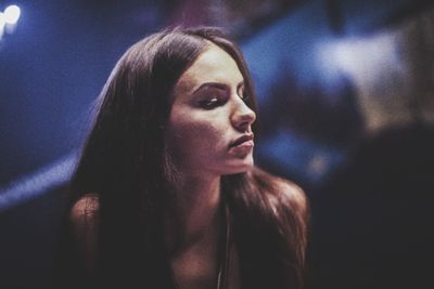 Young woman looking away in darkroom