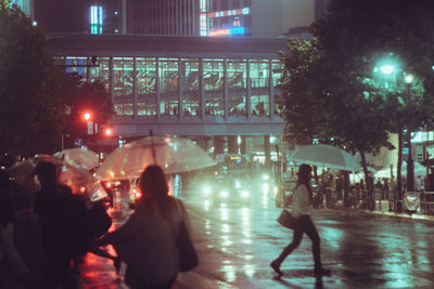 People on street in city at night