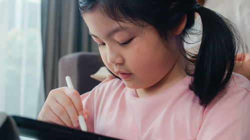 Close-up portrait of a girl looking away