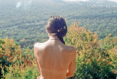 Rear view of topless woman