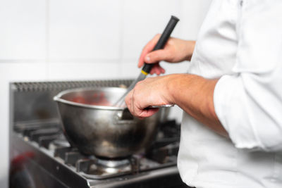 Midsection of man preparing food at home