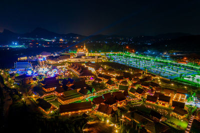 High angle view of illuminated buildings in city at night