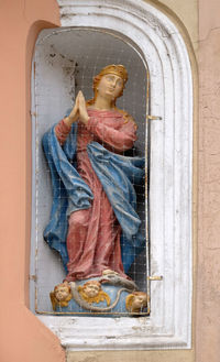 Statue of buddha in window