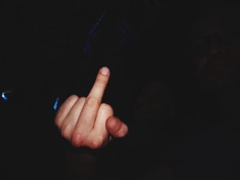 Close-up of human hand against black background