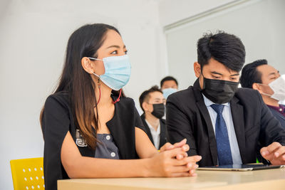 Business colleagues sitting in meeting at office