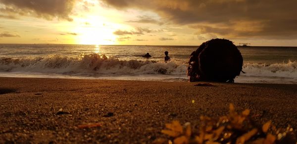 Scenic view of beach against sky during sunset