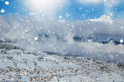 Scenic view of landscape during snowfall