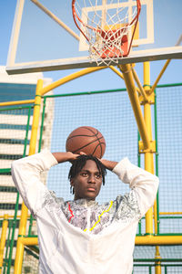 Portrait of man with basketball hoop