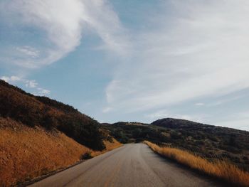 Scenic view of country road along mountain