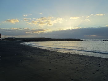 Scenic view of beach against sky during sunset