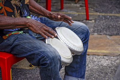 Midsection of musician playing musical equipment