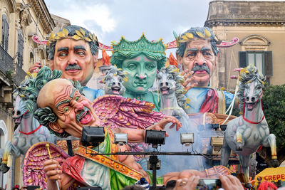 Low angle view of statues against sky