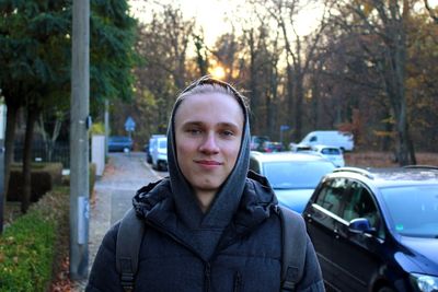 Portrait of man standing in car