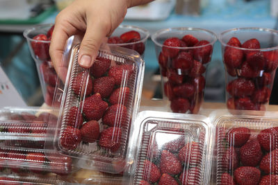 Midsection of woman holding strawberries