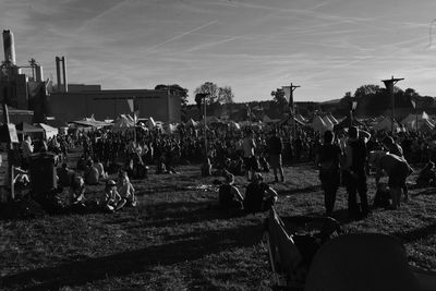 Group of people on field against sky