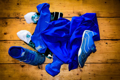 Directly above shot of blue soccer uniform and shoes on table