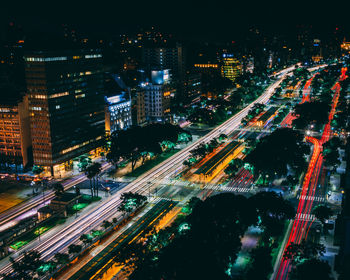 High angle view of illuminated city street and buildings at night