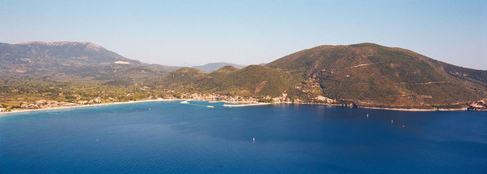 Panoramic view of sea and mountains against clear sky