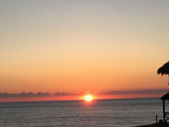 Scenic view of sea against clear sky during sunset