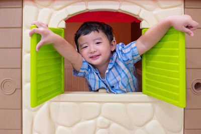 Portrait of cute boy in dollhouse