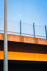 Low angle view of bridge against clear blue sky